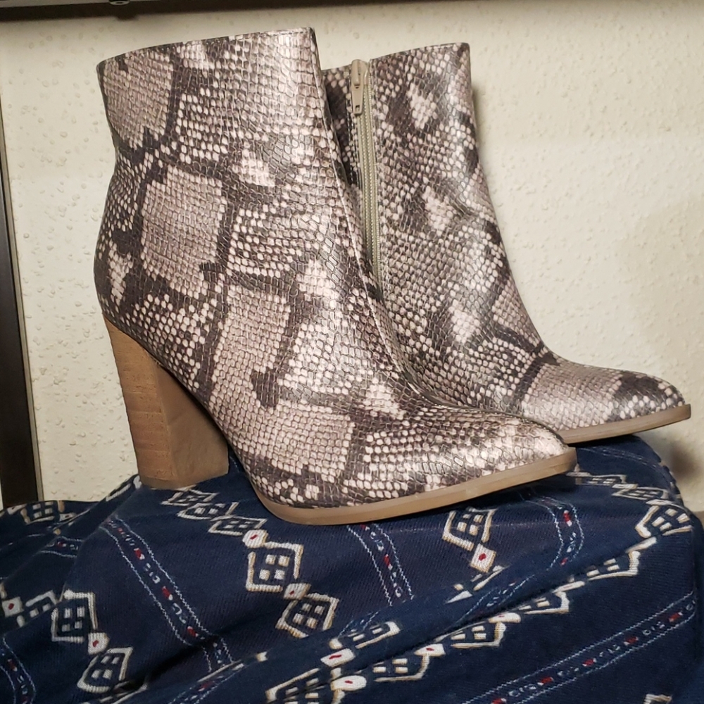 Faux snake heeled boots .
